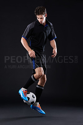 Buy stock photo Soccer, fitness and skill with man in studio for professional sports training isolated on black background. Control, freestyle and male athlete with Talent in football kit with juggling tricks.