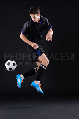 Buy stock photo Shot of a handsome soccer player isolated on black