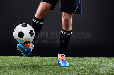 Buy stock photo Cropped shot of a soccer player playing soccer
