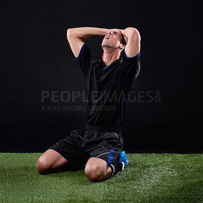 Buy stock photo Shot of a man looking disappointed after a game of soccer