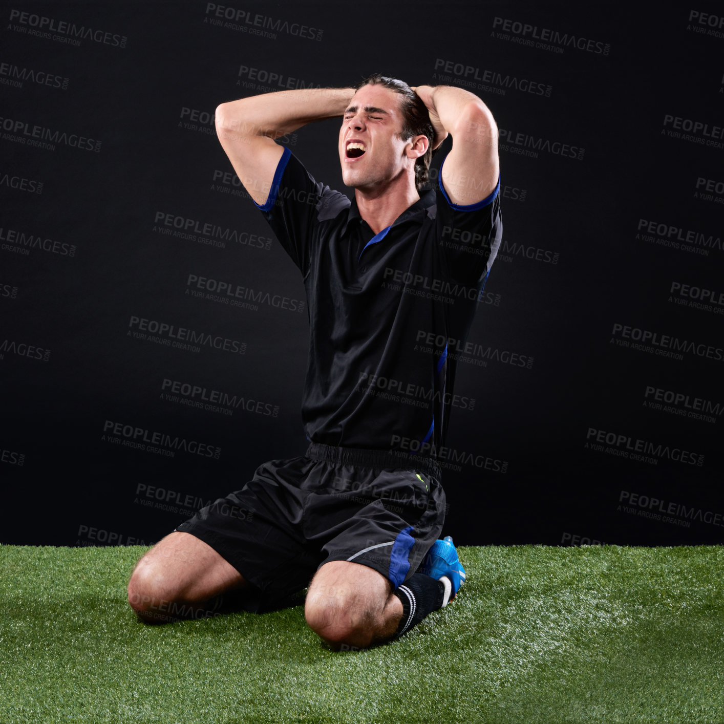 Buy stock photo Field, soccer player and man in grass, angry and lose in game, stress and upset on ground and outdoor. Black background, sad and athlete with hands, unhappy and person with shouting fail in football