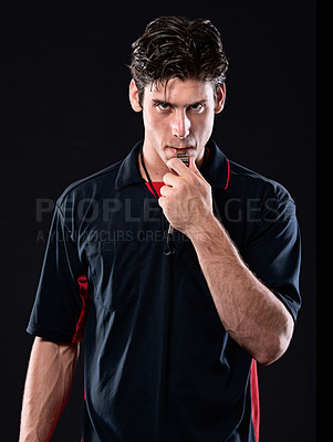 Buy stock photo Shot of a referee blowing his whistle