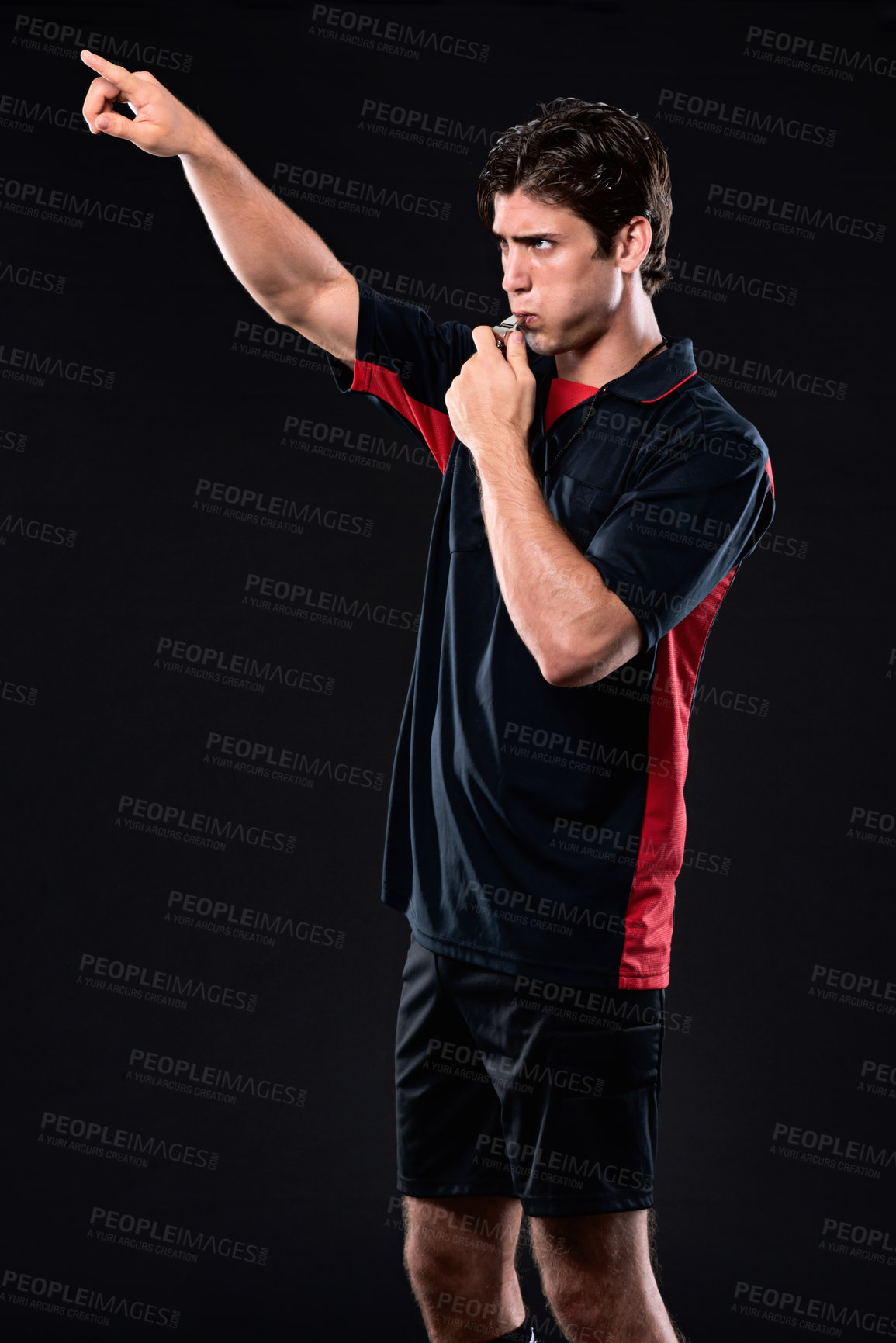 Buy stock photo Referee, pointing and blowing whistle in studio for decision in sport, hand for full time or stop. Male person, black background and review for penalty in game, call or sign with warning at night