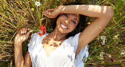 Buy stock photo Portrait, top view and woman in grass with flower in the countryside in summer, vacation and relax. Face, happy person in field above and floral plant at farm in nature, garden or outdoor in Brazil