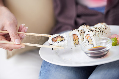 Buy stock photo Hands, sushi plate and chopsticks in closeup, home or eating for wellness, diet or meal with soy sauce. Hungry person, fish and dish at lunch, nutrition or snack for takeaway food, house or apartment