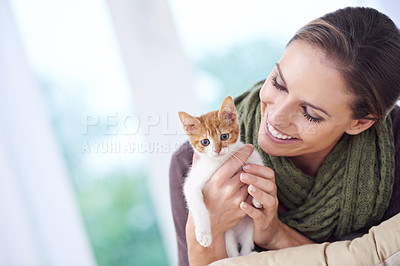 Buy stock photo Happy, love and woman with kitten in home for bonding, friendship and relax together on sofa. Animal care, house and person with adorable, cute and young cat on couch for playing, embrace and hug