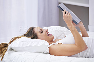 Buy stock photo Excited woman, bedroom and tablet for online streaming, reading news or watch funny video on social media. Young person relax on bed with wow, happy or laughing on digital technology or web at home