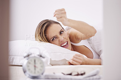 Buy stock photo Sleeping, frustrated and woman in bed with alarm for snooze, wake up and morning routine in home. Lazy, tired and person unhappy, angry and upset in bedroom for time, clock and ringing in apartment