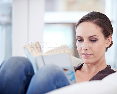 Buy stock photo Woman, book and reading on sofa to relax for story, novel and learning knowledge in living room at home. Lady, fiction books or break to enjoy literature, hobby or comfortable rest on couch in lounge