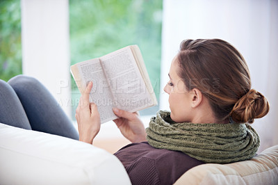 Buy stock photo Woman, book and reading from the back on sofa for story, novel and learning knowledge in living room at home. Lady, fiction books and relax with literature, hobby and comfortable on couch in lounge