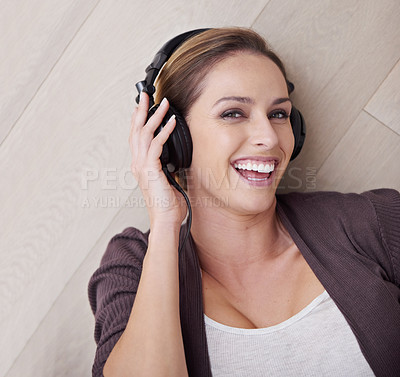 Buy stock photo Happy woman, headphones for music and top view with face and listening to song, relax at home with technology. Podcast, radio and audio streaming, laying on floor with smile in portrait and album