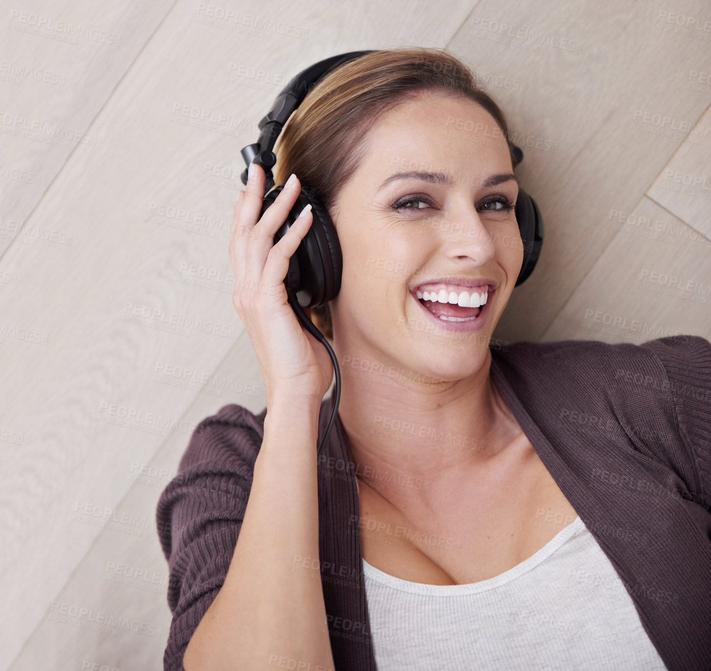 Buy stock photo Happy woman, headphones for music and top view with face and listening to song, relax at home with technology. Podcast, radio and audio streaming, laying on floor with smile in portrait and album