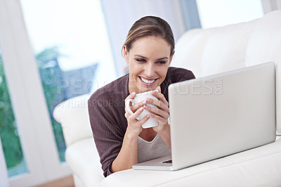 Buy stock photo Coffee, happy woman and laptop on a sofa for streaming movie, film or online video home. Face, smile and female person relax in a living room with pc, tea or social media, subscription or service