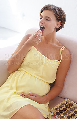 Buy stock photo Happy woman, eating chocolate and pregnant in home, alone and enjoying delicious pregnancy craving. Good mood, comfort food and candy dessert for maternity, snack and sweet tooth satisfaction