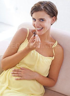 Buy stock photo Pregnant woman, eating chocolate and happy in home, alone and enjoying delicious pregnancy craving. Good mood, comfort food and candy dessert for maternity, snack and sweet tooth satisfaction
