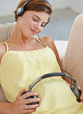 Buy stock photo Pregnant woman, music or headphones on belly or stomach for sound, audio or listening for brain development. Relax, pregnancy or mother in home with podcast radio for bonding, baby or growth support
