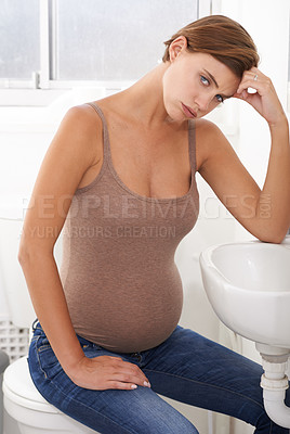 Buy stock photo Nausea, pregnant woman and morning sickness in portrait, bathroom and uncomfortable person. Exhausted, moody and frustrated with illness, pregnancy and struggling with migraine pain on basin