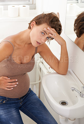 Buy stock photo Nausea, pregnant woman and morning sickness in basin unhappy and hand on stomach for discomfort. Exhausted, moody and frustrated with illness, pregnancy and struggling with migraine pain on sink