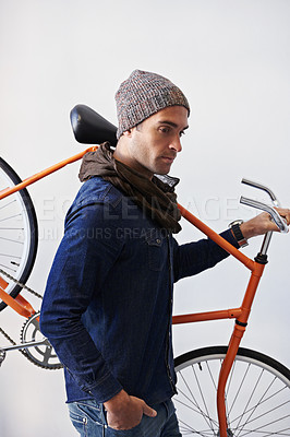 Buy stock photo Bicycle, walking and man in building carrying bike for healthy and eco friendly transportation for travel. White background, thinking and cyclist with hipster and journey for carbon neutral commute