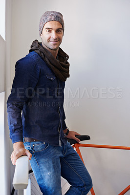 Buy stock photo Portrait, fashion and bike with man in hallway of home for travel, transport or commute. Apartment, sustainability and zero emission bicycle with confident young person on stairwell in winter style
