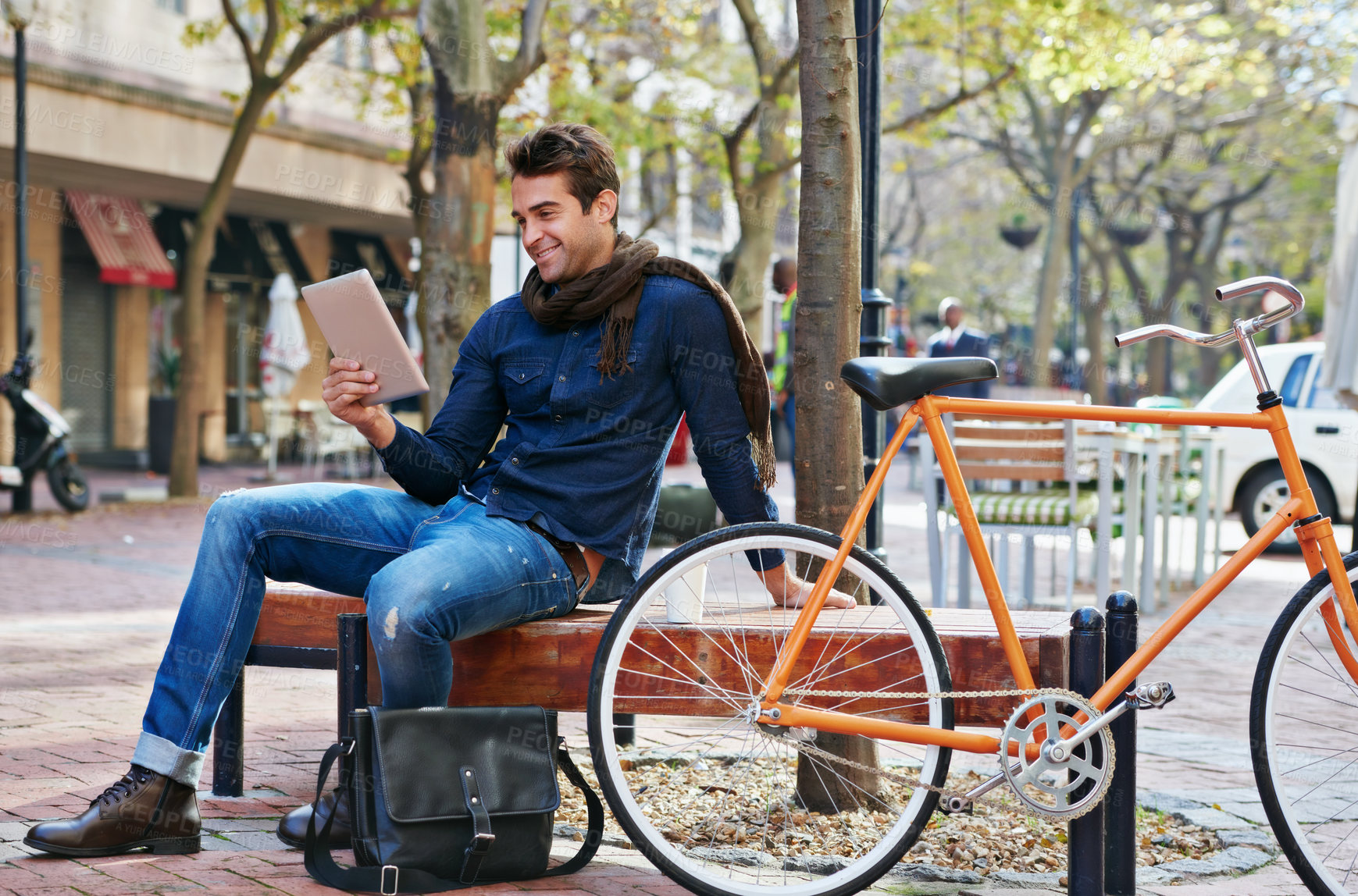 Buy stock photo Happy, city and smile with man, tablet and bicycle with adventure and digital app with email and social media. Person on bench, outdoor and New York with guy and technology with connection and typing