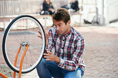 Buy stock photo Maintenance, bicycle and wheel with man, city and inspection with adventure and fixing bike. Cyclist, guy and outdoor with person and travel with transportation and eco friendly with sustainability 