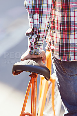 Buy stock photo Hands, person and travel on bicycle in city on eco friendly transport outdoor, commute or walk. Cycling, back or push bike in urban town, street or road for journey with rear view of seat on sidewalk