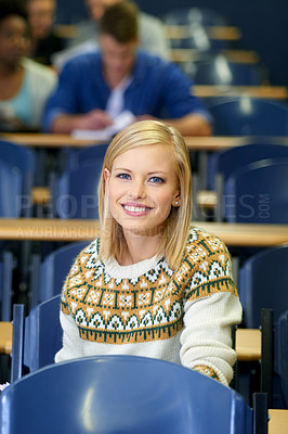 Buy stock photo University student, portrait and smile at desk in lecture hall in London for english class. education or scholarship. Female person, face and academy for teaching or learning course, lesson or exam