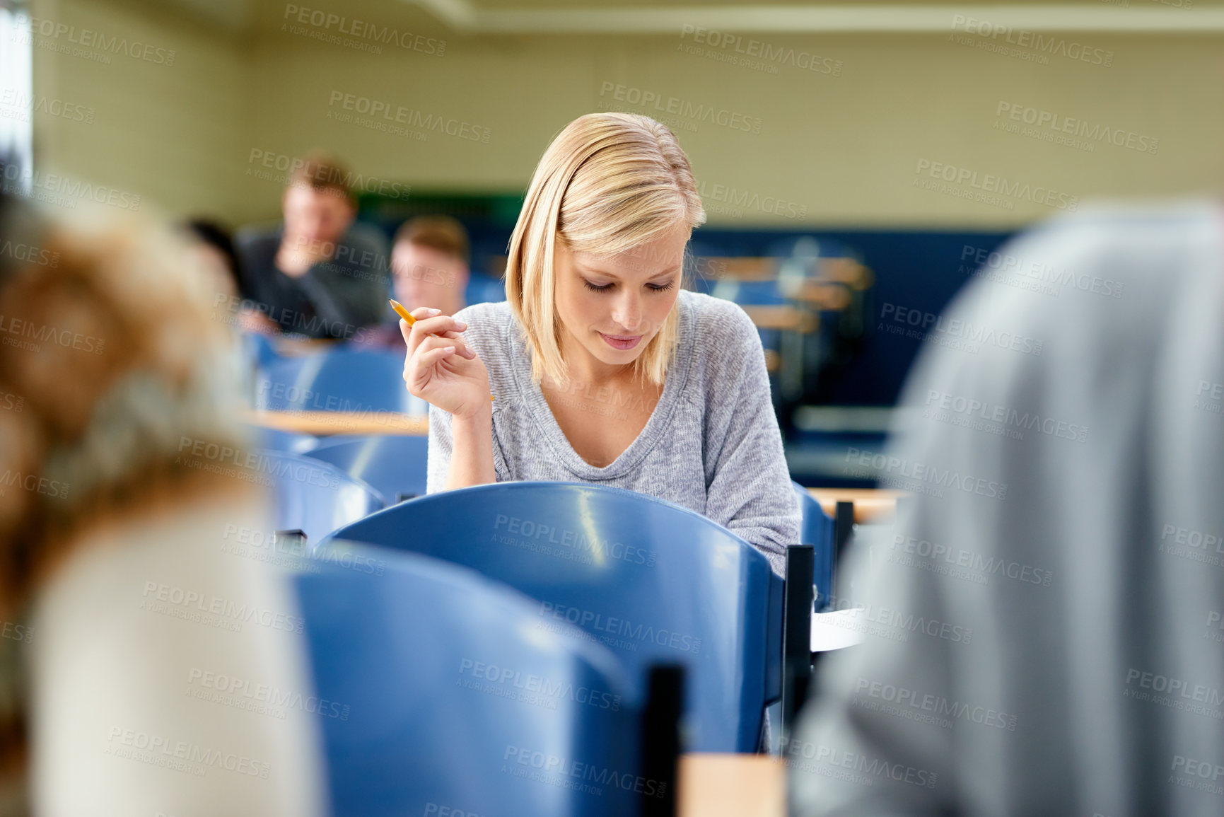 Buy stock photo Woman, thinking and exam with pen in classroom for idea, brainstorming and assessment at campus. Female student, planning and sitting with paper for education, knowledge and growth in university