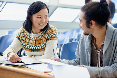 Buy stock photo Conversation, college and students in classroom for studying with text book for test or exam. Discussion, writing and young people working on university assignment together in lecture hall at academy