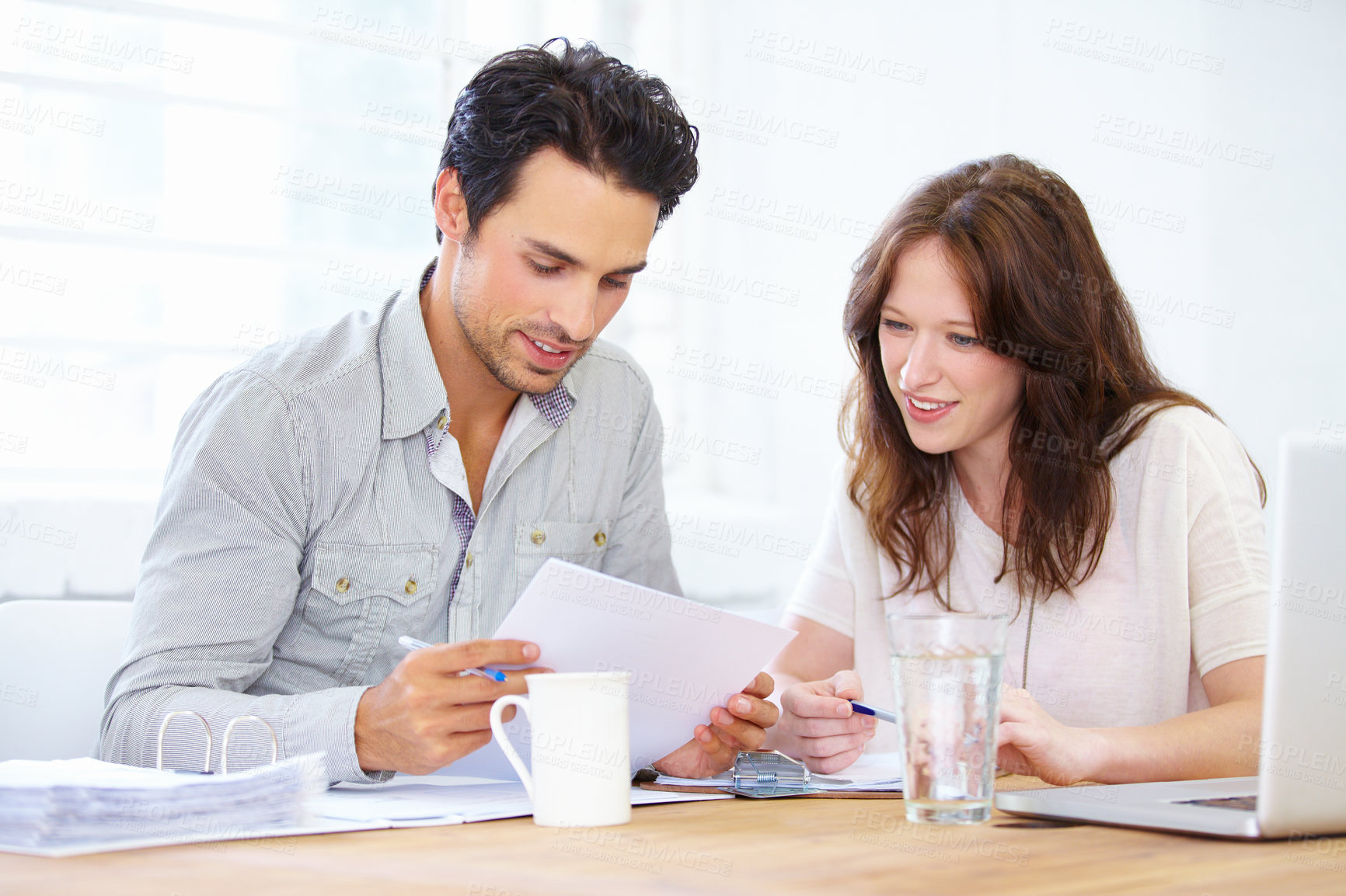 Buy stock photo Documents, planning and business people or partner in meeting collaboration, teamwork or financial review. Startup man and woman with paperwork talking, feedback or advice on finance, taxes or profit