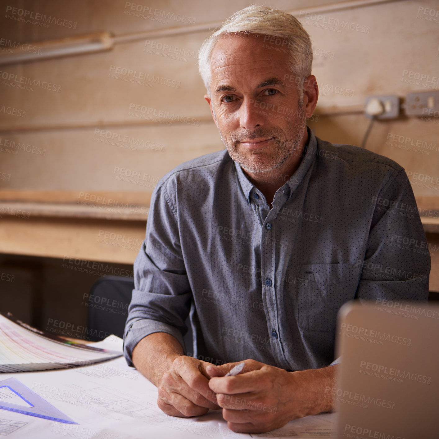 Buy stock photo Portrait, laptop and senior architect in workshop, smile and career in construction industry. Man, contractor and entrepreneur of startup, small business and paperwork with design for planning