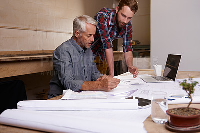 Buy stock photo Architect, teamwork and men with blueprint in workshop for collaboration. Senior engineer, design and father and son planning, discussion and working on building project of apprentice with mentor.