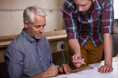 Buy stock photo Architect, teamwork and men with blueprint in workshop for building construction. Senior engineer, father and son working on design, project and planning of apprentice and mentor with paperwork.