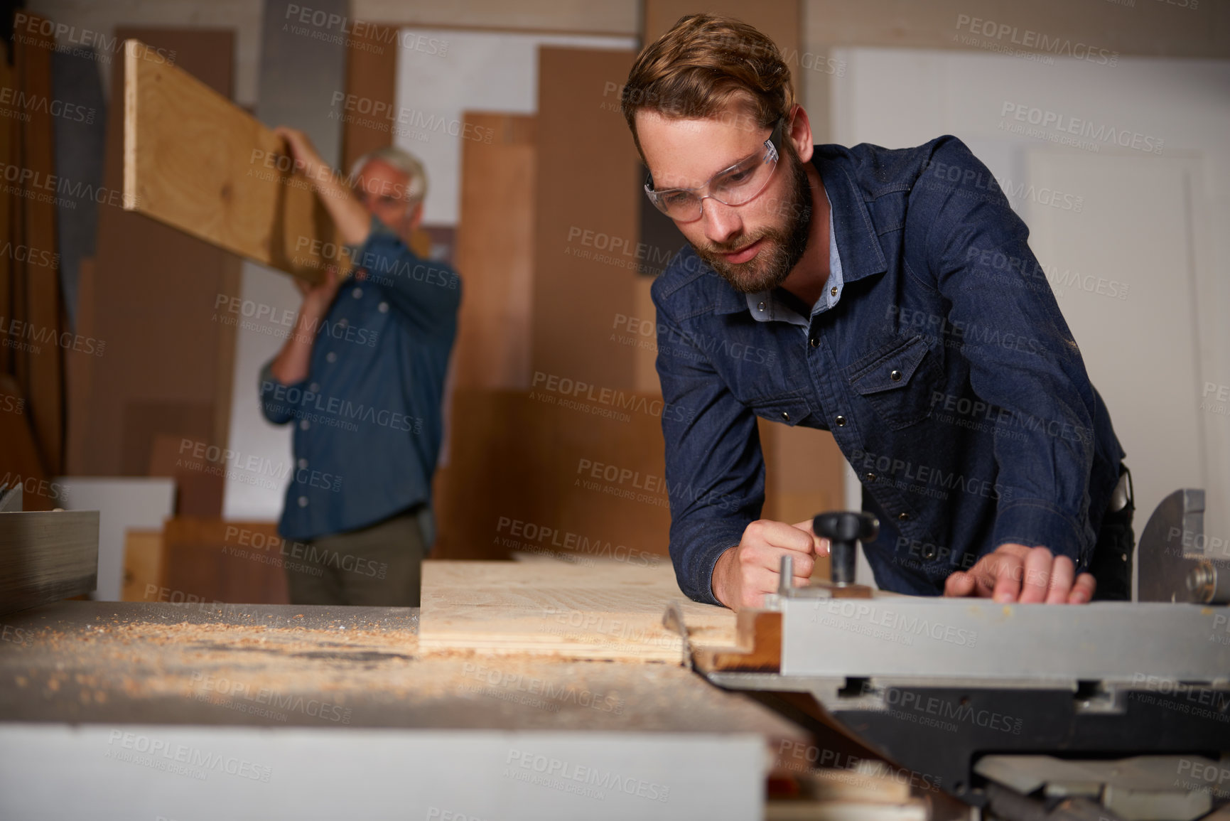 Buy stock photo Carpentry team, carpenter and men work in workshop on design project with vocation and creative skill. Collaboration, teamwork and male cutting wood with power tools, father and son working together
