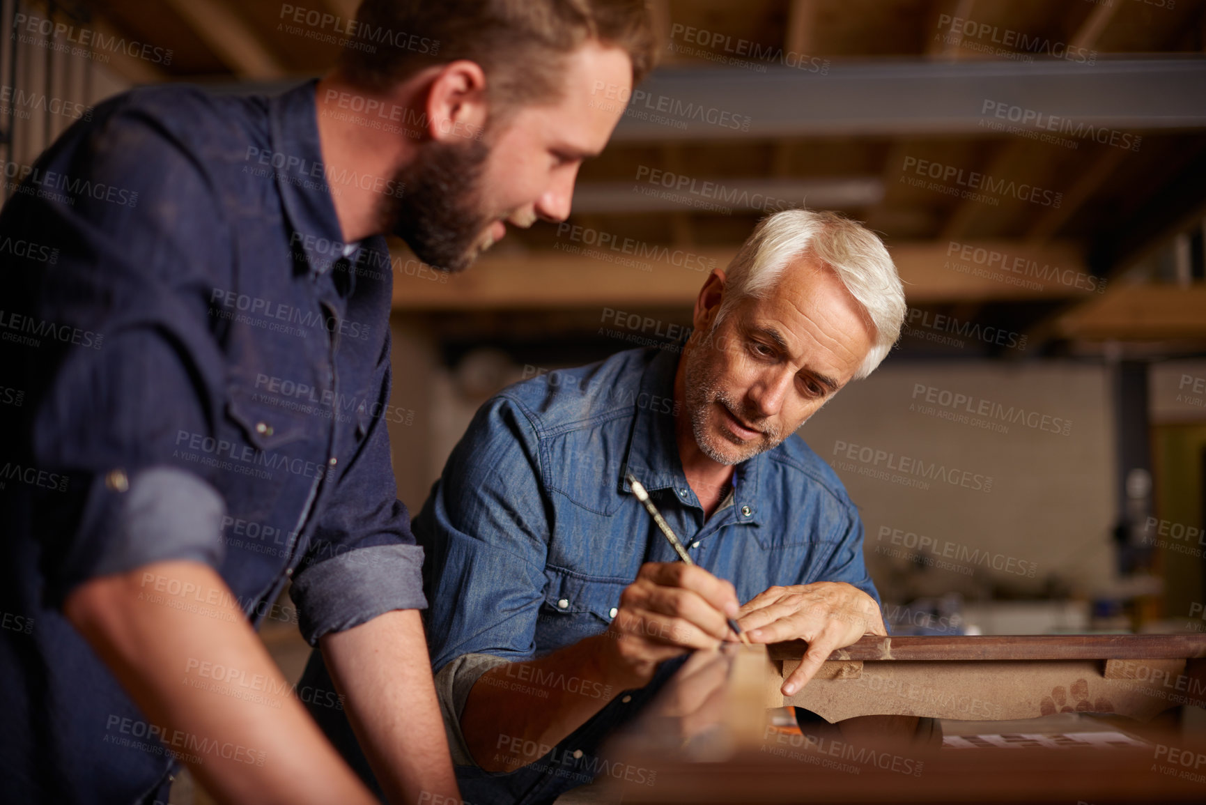 Buy stock photo Carpentry, learning and man with apprentice in training, teaching and tips for professional furniture manufacturing. Mentorship, expert carpenter and student working at wood design project workshop.