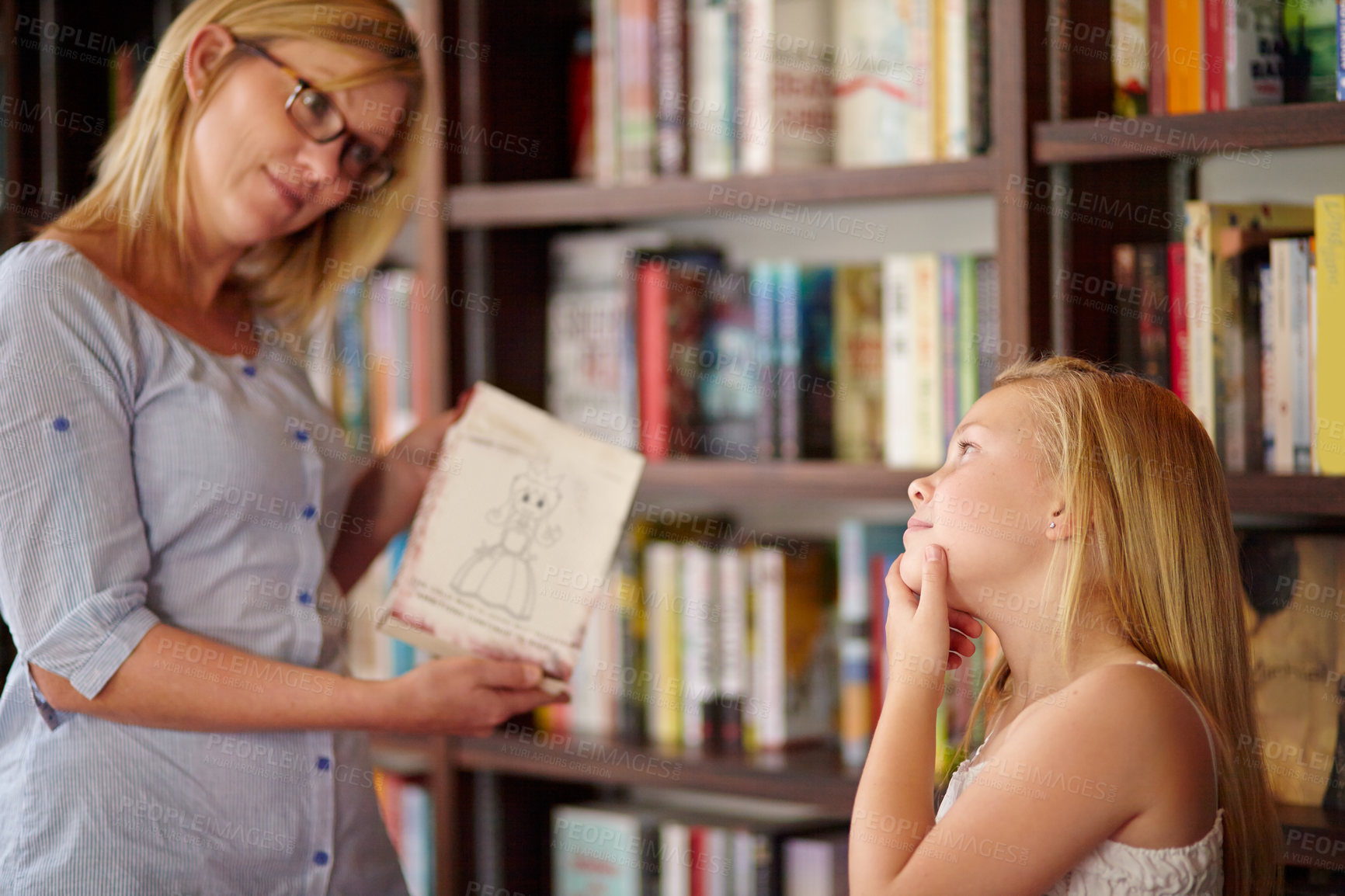 Buy stock photo Thinking, books and mother with child in library with choice, learning and relax with reading knowledge. Storytelling, happy mom and girl at bookshelf together with story, decision and education.