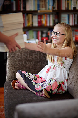 Buy stock photo A cute little blonde girl smiling as someone brings her a stack of books in a library