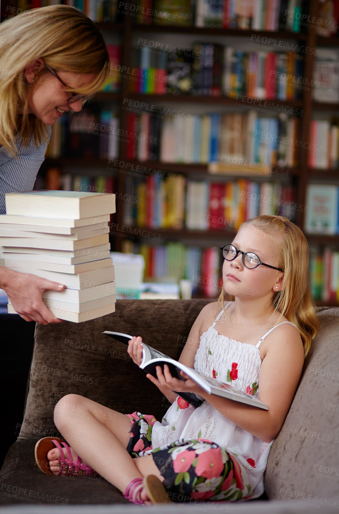 Buy stock photo Reading, books and woman with child in library with stack, learning and relax with study knowledge. Storytelling, happy mom and girl in bookstore together with story, fantasy and education on couch.
