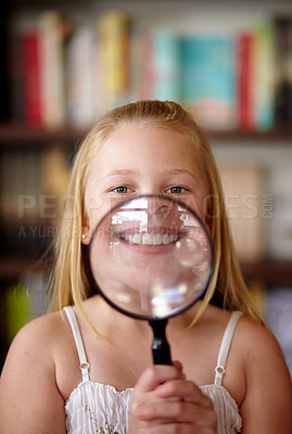 Buy stock photo Portrait, library and child with a magnifying glass on her smile for education, inspection and studying. young, confident and a girl, kid or student with equipmwnt for a search or attention on mouth