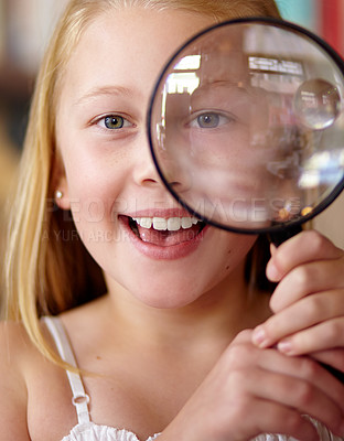 Buy stock photo Happy, portrait and a child with a magnifying glass in a library for education, learning or inspection. Smile, young detective and a girl, kid or student with equipment for studying or attention