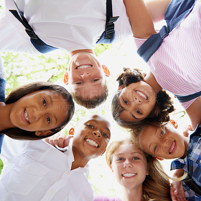 Buy stock photo Children, happiness and huddle in portrait outdoor, trees and sunshine with solidarity in city. Students, teenager or together in diversity on school playground, summer or education in below in town