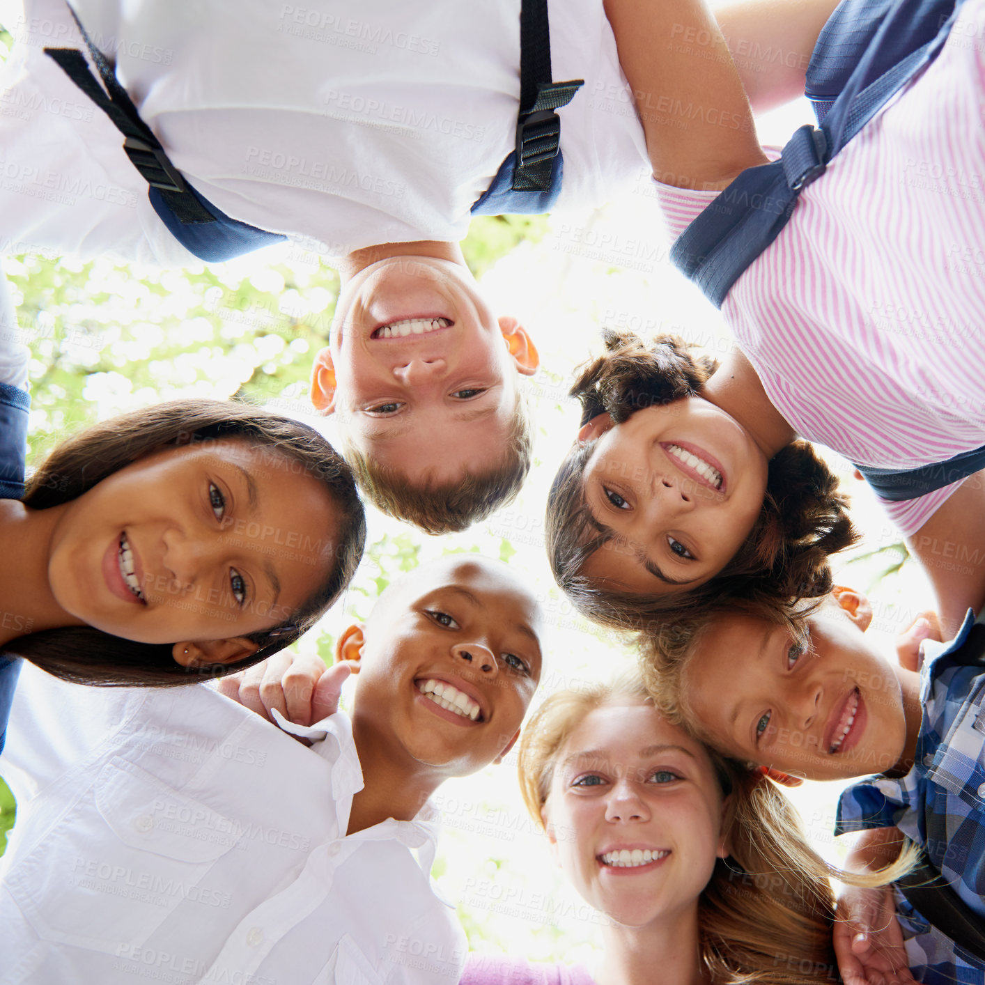 Buy stock photo Children, happiness and huddle in portrait outdoor, trees and sunshine with solidarity in city. Students, teenager or together in diversity on school playground, summer or education in below in town