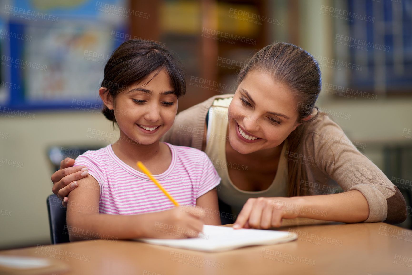 Buy stock photo School, education or scholarship with a student and teacher in a classroom together for writing or child development. Study, learning and teaching with a woman educator helping a girl child in class