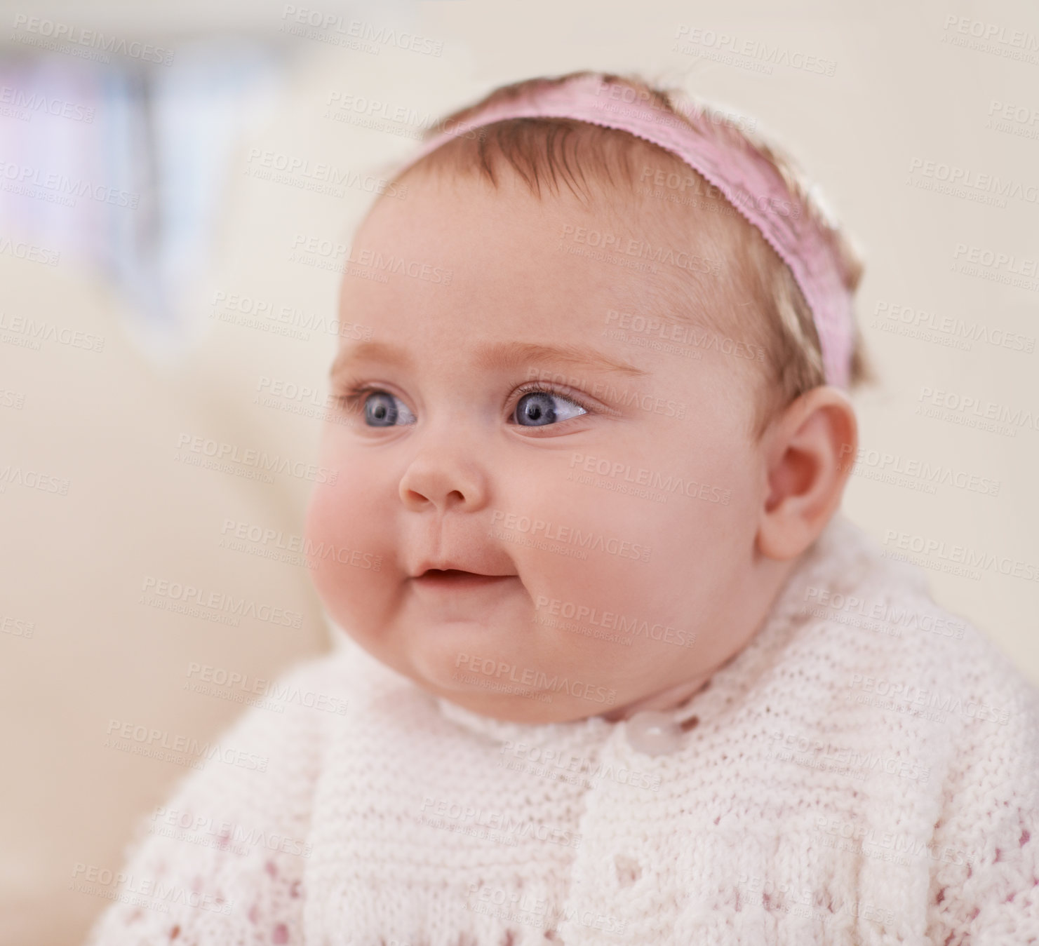 Buy stock photo Happy, baby and face in a home with a cute, relax and sweet infant in a living room. Youth, child and house with toddler clothing in the morning ready for play on the sofa with joy and headband