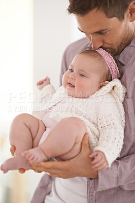Buy stock photo Love, father and baby with kiss in home for bonding, comfort and playing together for healthy development. Family, man and newborn child with smile, embrace and relax for parenting, care and security