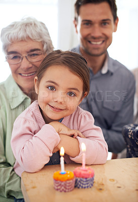 Buy stock photo Girl kid in portrait, birthday party and cupcake with candle for celebration, family and smile for special event at home. Grandmother, father and child with happy people for anniversary and dessert