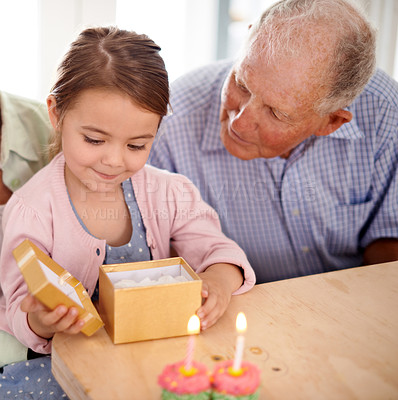 Buy stock photo Grandfather child and open gift box, birthday party with celebration for special event and happy family at home. Old man with young girl, unboxing present with gratitude and cupcake for dessert
