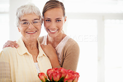 Buy stock photo Senior woman, daughter and portrait with bouquet, present or care for love, hug or reunion at family home. People, elderly mom and mothers day celebration for connection, gift or flowers in apartment
