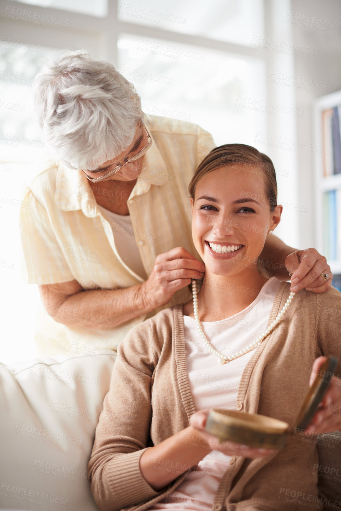 Buy stock photo Home, necklace and portrait of senior mother and woman for present, gift and surprise in living room. Family, happy and daughter with mom giving pearls on sofa for celebration, birthday and bonding